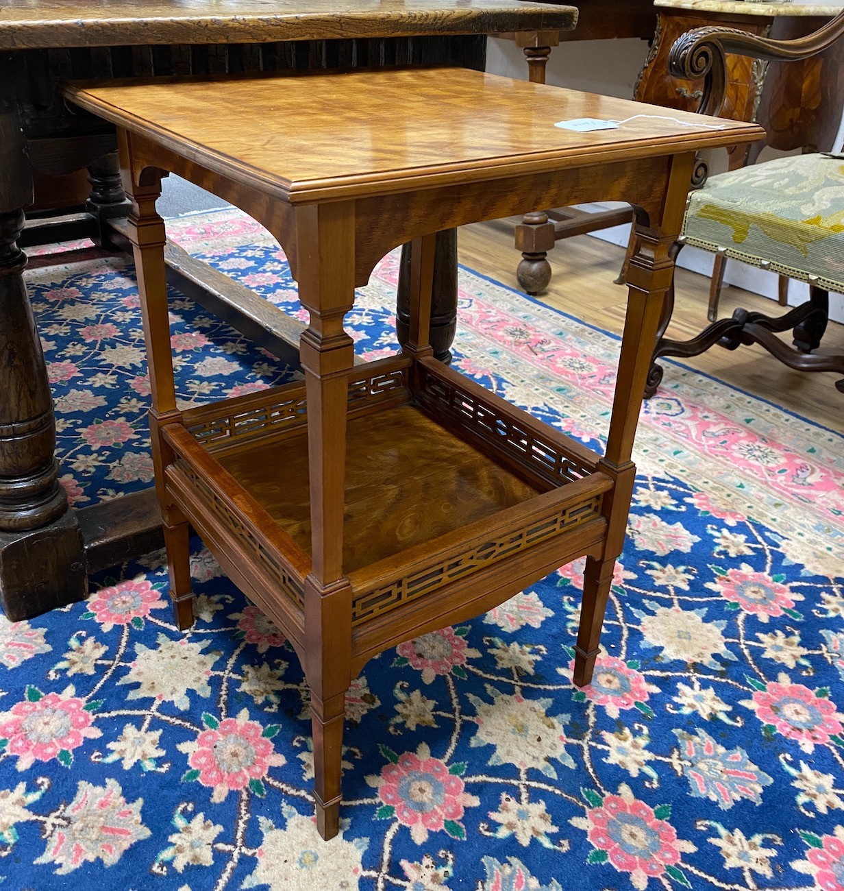 An Edwardian square satinwood two tier occasional table, width 48cm, height 68cm